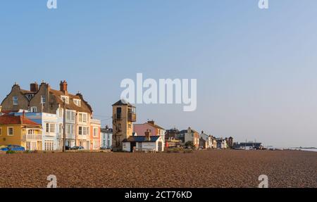 View of Aldeburgh Beach with early morning sunlight and blue sky. Stock Photo