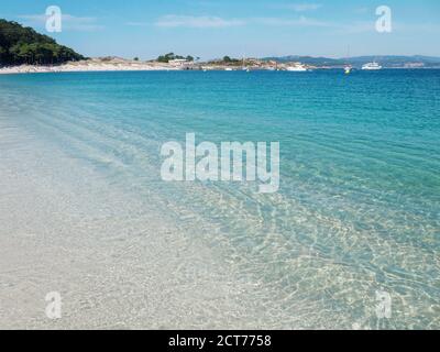 Crystal clear blue sea at the Cies islands. Turquoise shallow water and white Rodas sandy beach. Stock Photo