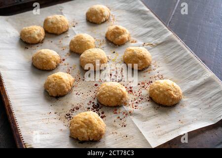Ghreyba (Coconut Moroccan Cookies): Freshly baked cookies on a parchment paper-covered sheet pan Stock Photo