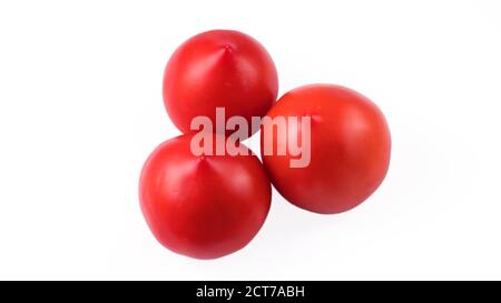 Three whole red tomatoes on a white background in isolation Stock Photo
