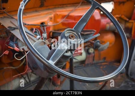 nterior of an orange demolished Volkswagen van with steering wheel Stock Photo