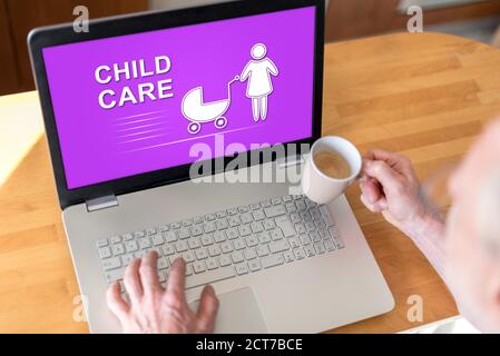 Man using a laptop with child care concept on the screen Stock Photo