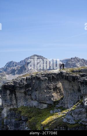 Hikers enjoying the panorama on Monte Piano in the Sexten Dolomites in South Tyrol, Italy. Stock Photo