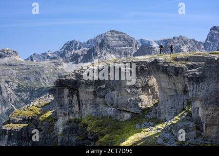 Hikers enjoying the panorama on Monte Piano in the Sexten Dolomites in South Tyrol, Italy. Stock Photo