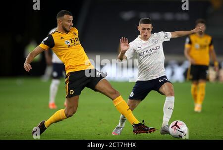 Wolverhampton Wanderers' Romain Saiss (left) and Manchester City's Phil Foden battle for the ball during the Premier League match at Molineux, Wolverhampton. Stock Photo