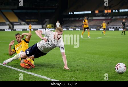 Wolverhampton Wanderers' Romain Saiss (left) fouls Manchester City's Kevin De Bruyne which results in a penalty during the Premier League match at Molineux, Wolverhampton. Stock Photo