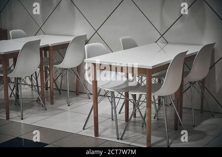 White stools and white tables at cafe Stock Photo