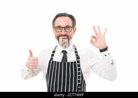 best and perfect. best mature male cook isolated on white. confident chef in apron. perfect cooking in kitchen. bearded man baker in glasses. catering business. thumb up and ok gesture. be the best. Stock Photo