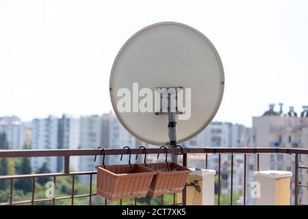 Satellite dish mounted on apartment balcony in Turkey Stock Photo