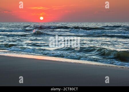 Sunset over rough seas Stock Photo