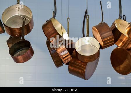 Decorative display of copper pots, pans, from ceiling. Stock Photo