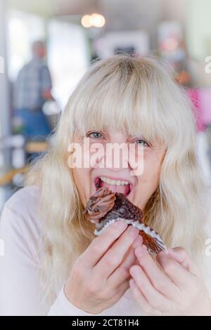 Woman eating cupcake, cake Stock Photo