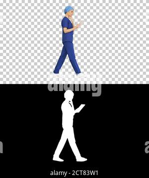Young woman doctor or nurse in scrubs using a touchscreen comput Stock Photo