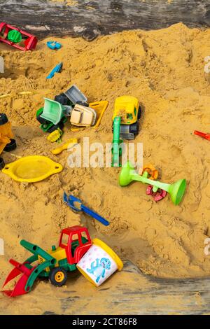 Sandpit, on a children's playground, sandpit with various toys made of plastic, excavator, shovels, molds Sauerland, NRW, Germany Stock Photo