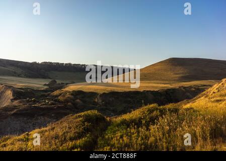 South West Coast Path through the hilly Dorset landscape near Chapman's Pool on the Isle of Purbeck, Dorset, England, UK Stock Photo