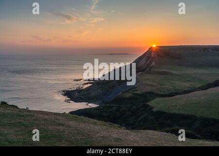 Sunset over Chapman's Pool on the Isle of Purbeck as seen from the South West Coast Path in Dorset, England, UK Stock Photo
