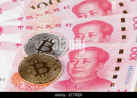Collage of New Chinese 100 RMB or Yuan featuring Chairman Mao on the front of each bill and Bitcoins Stock Photo