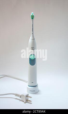 Electric toothbrush on charging stand with North American plug Stock Photo