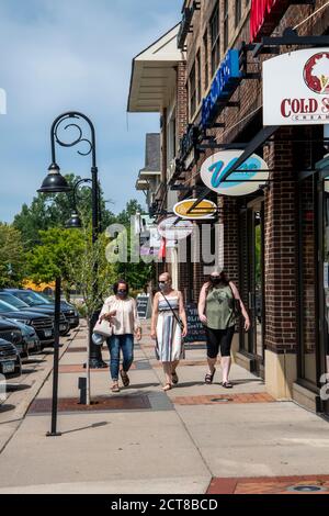 Mendota Heights, Minnesota. Three women wear masks outside during a shopping trip to their local mall to protect themselves from the coronavirus. Stock Photo