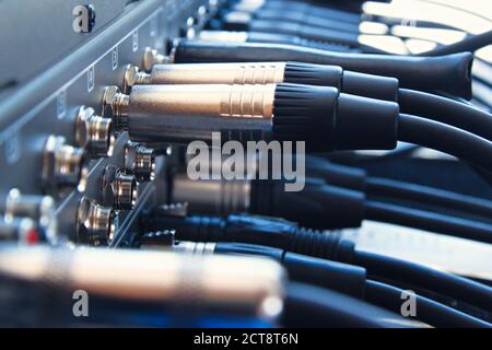 Close up audio jacks cable plugged into mixer console. XLR audio cable Stock Photo
