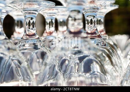 Wine glasses on a table outdoor. Focus blurred foreground, defocused background bokeh Stock Photo