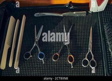 Hair-cutting equipment laying on a table in a barbershop Stock Photo