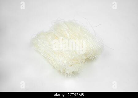 uncooked dry glass noodle, white bean asian vermicelli, rice noodles, isolated on white Stock Photo
