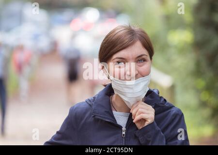 Young woman is wearing face mask wrong, nose uncovered Stock Photo