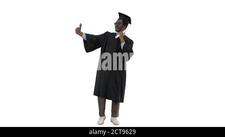 Happy african american male student in graduation robe taking ph Stock Photo