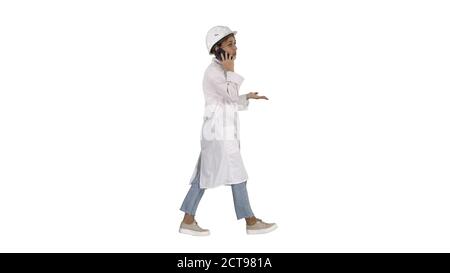 Female scientist making a call walking on white background. Stock Photo