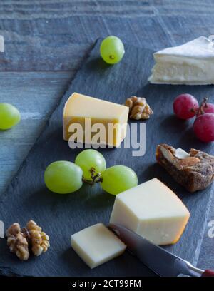 Cheese platter witch assorted cheese and grapes Stock Photo
