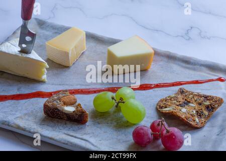 Cheese platter witch assorted cheese and grapes Stock Photo