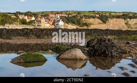 Reflections in the still rock pools of  Robin Hoods Bay on the North Yorkshire coast. Stock Photo