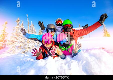 Group happy friends man snd woman snowboarders and skiers having crazy fun ski resort winter forest Stock Photo
