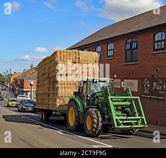 Early autumn in Burscough and it’s time for the straw harvested from the surrounding fields to be taken for dry storage by tractor and trailer. Stock Photo