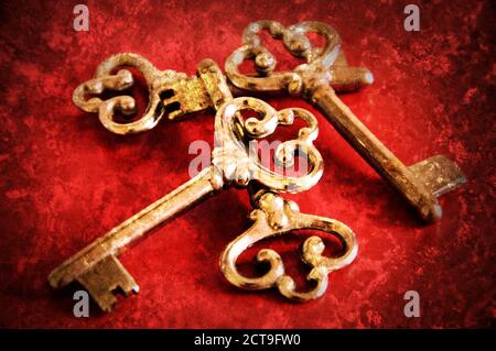Four vintage keys. Retro aged toned photo with scratches. Stock Photo