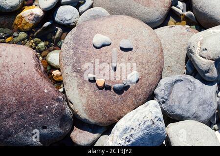 New Zealand, Marlborough Sounds, Pelorus river, smiley made of stones Stock Photo