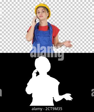 Young female worker talking on phone while walking, Alpha Channe Stock Photo