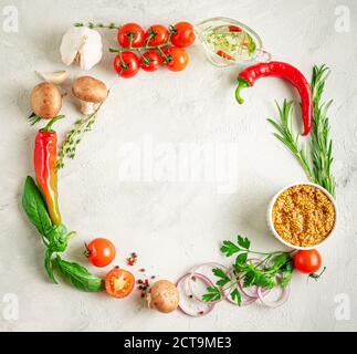 Food frame mockup. Various herbs, spices and vegetables on gray concrete background. Top view, copy space Stock Photo