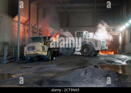 Germany, Steel mill, removal of slag with shovel excavator Stock Photo