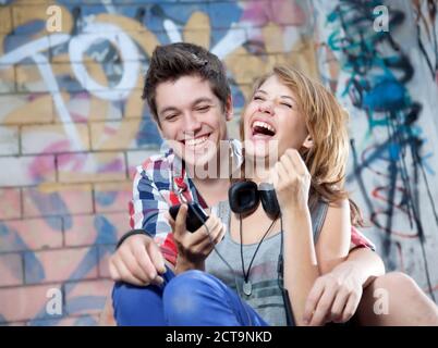 Germany, Berlin, Teenage couple laughing Stock Photo