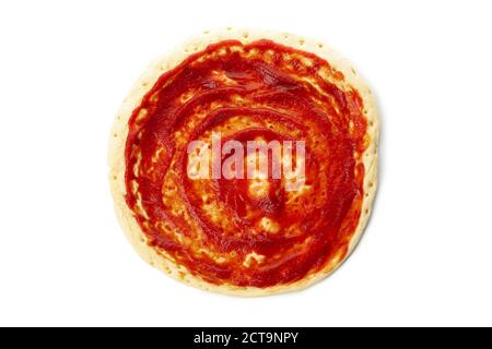 Rolled out pizza dough with sauce isolated on white background Stock Photo