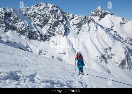 Austria, East Tyrol, Defereggental, Man backcountry skiing Stock Photo