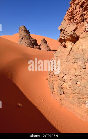 Algeria, Sahara, Tassili N'Ajjer National Park, Rock towers in the sand dunes of Tin Merzouga Stock Photo
