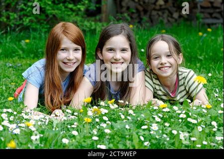 Girls are lying in a flower meadow Stock Photo