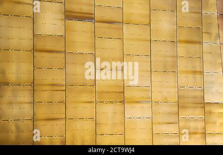 Golden bronze alloy roofing tiles shining in the summer sunshine Stock Photo