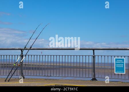 Fishing Rod Against Blue Ocean or Sea Background, Copy Space