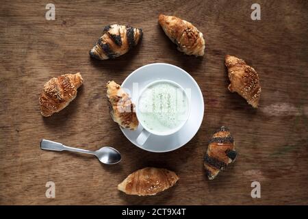 Mini croissants and cup of Matcha Latte Stock Photo