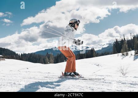 Germany, Bavaria, Winklmoosalm, Mature woman skiing downhill Stock Photo