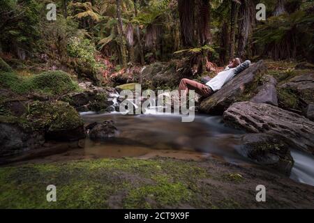 New Zealand, Whakapapa area, Tupapakurua falls, man lying on a brook Stock Photo